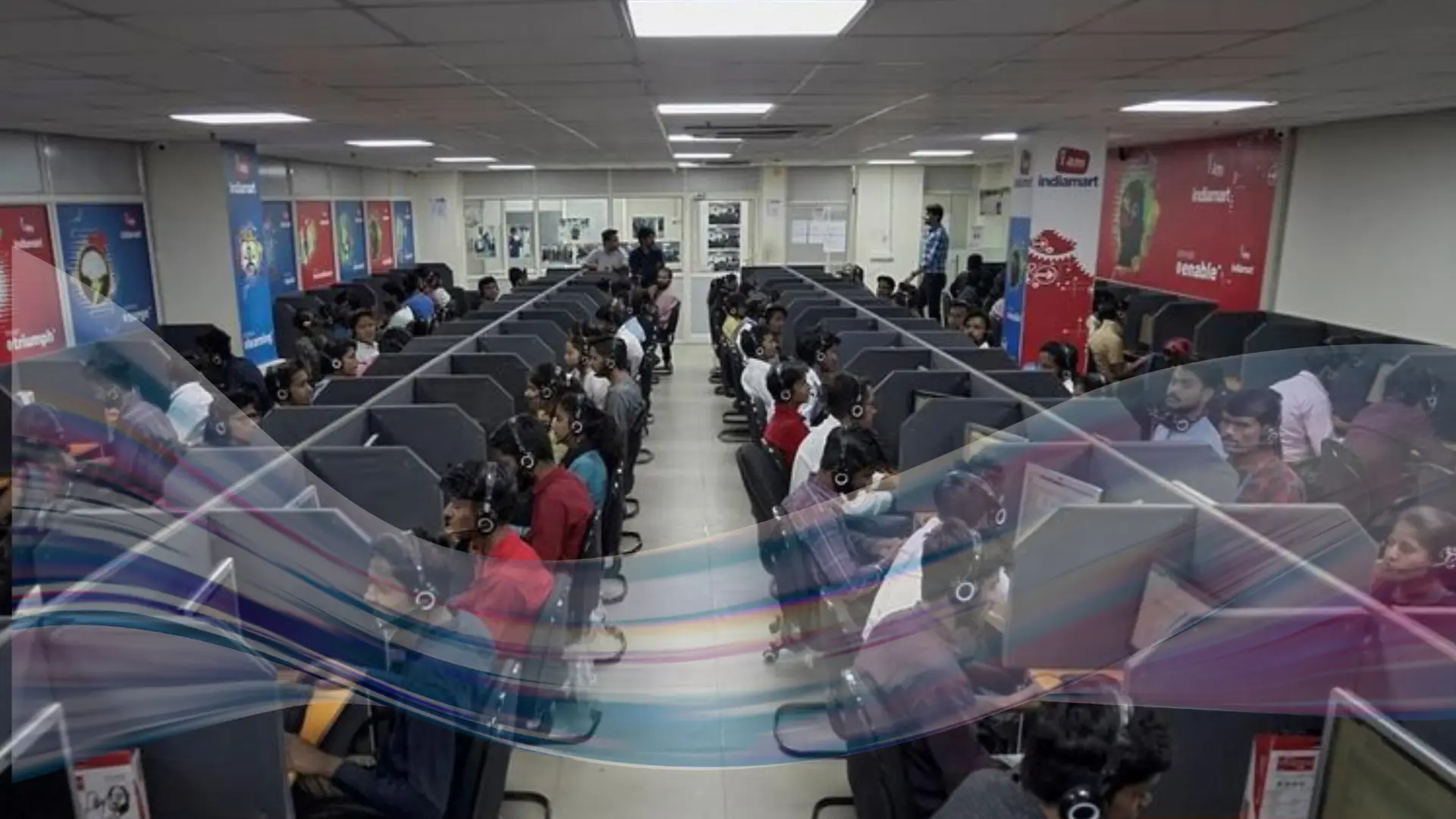 Reliable Offshore Call Center Partner Beatrix Konnect A large call center with rows of workers sitting at individual cubicles, wearing headsets and looking at computer screens. The room is brightly lit, and the atmosphere appears busy and focused.